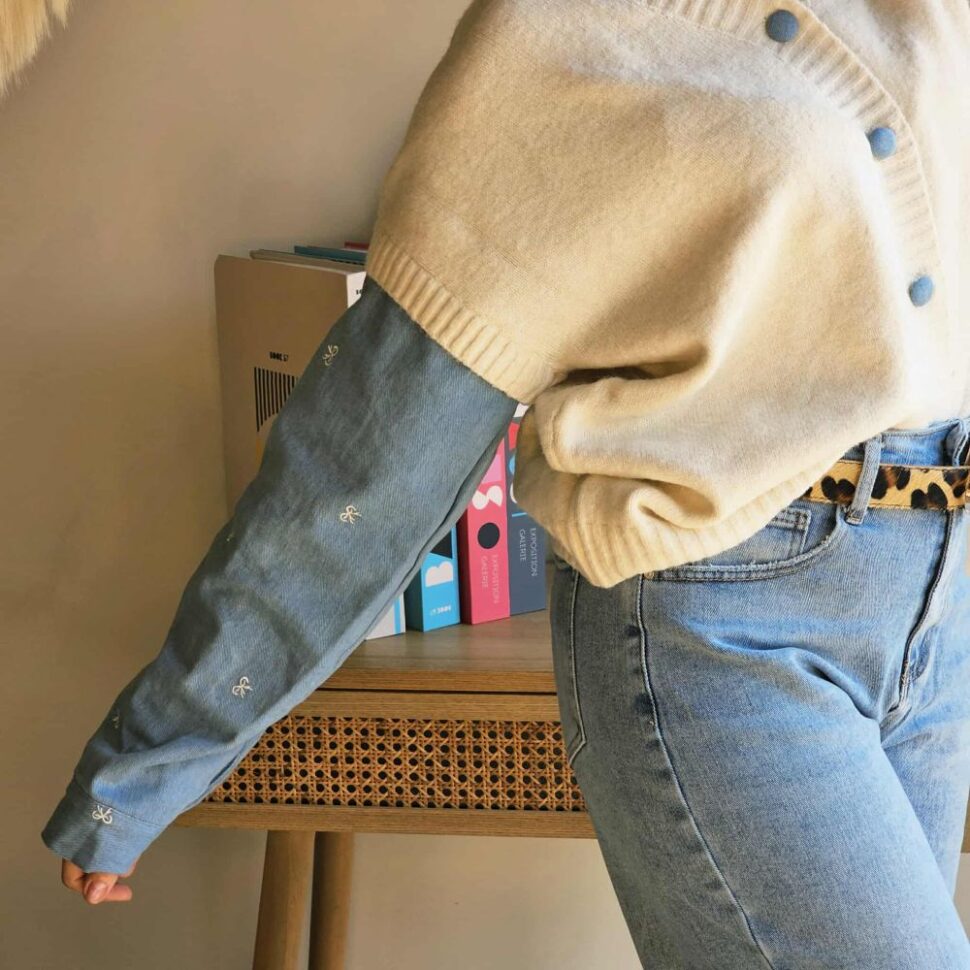 Pull femme et ses boutons et manches en jeans clair